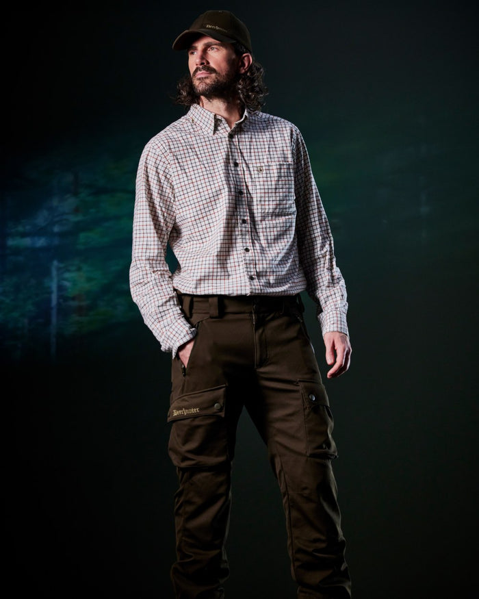 Art Green coloured Deerhunter Mens Muflon Pro Light Trousers on forest background #colour_art-green