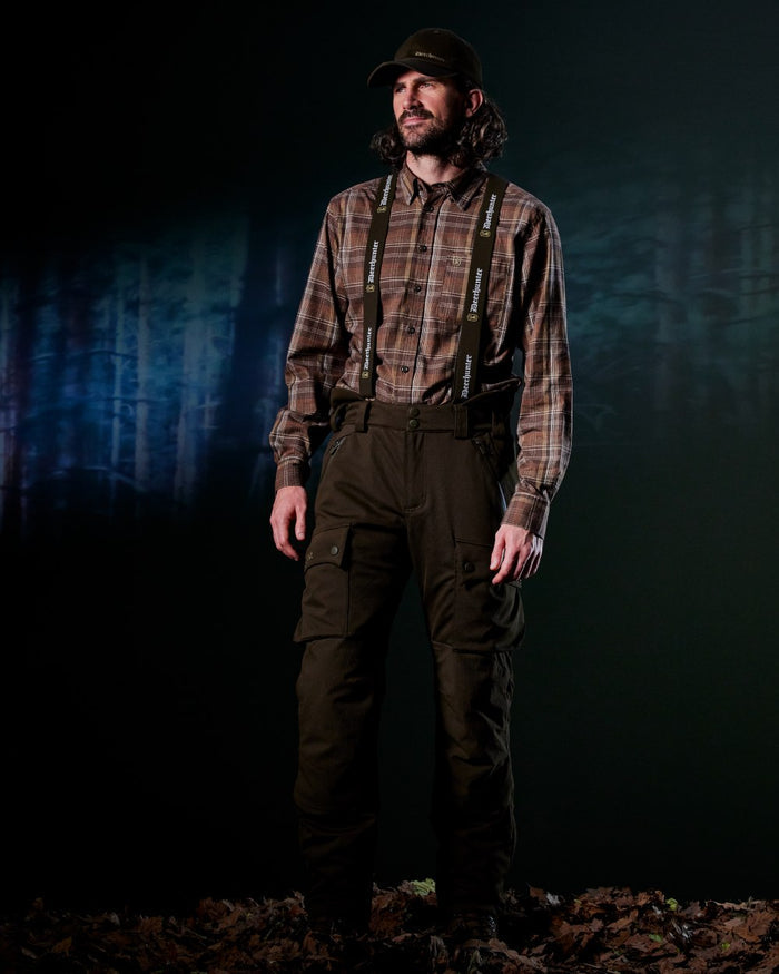 Art Green coloured Deerhunter Mens Muflon Pro Trousers on forest background #colour_art-green
