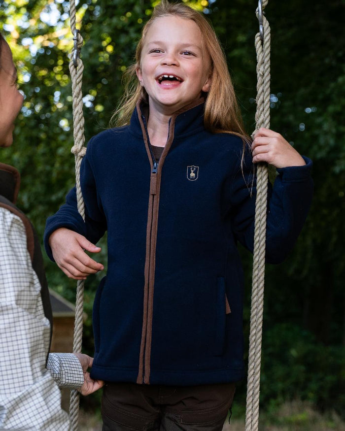 Dark Blue Coloured Deerhunter Youth Cumbria Fleece Jacket on forest background #colour_dark-blue