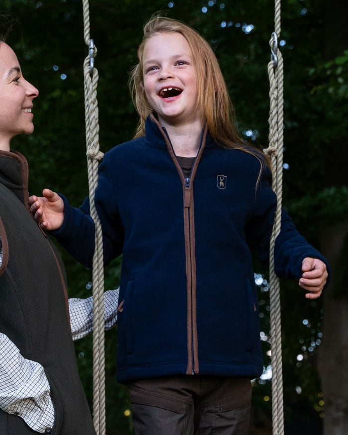 Dark Blue Coloured Deerhunter Youth Cumbria Fleece Jacket on forest background #colour_dark-blue