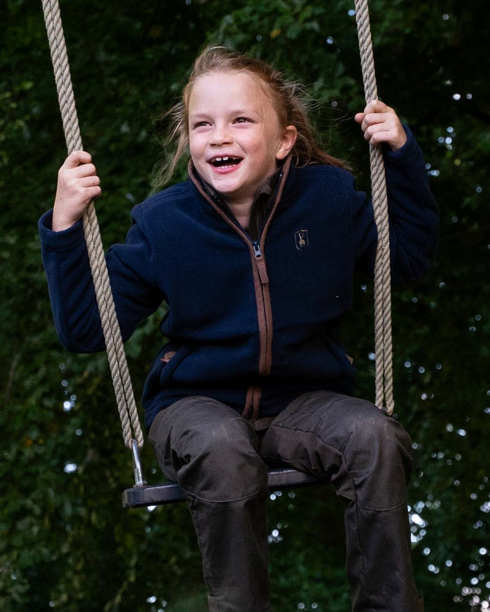 Dark Blue Coloured Deerhunter Youth Cumbria Fleece Jacket on forest background #colour_dark-blue