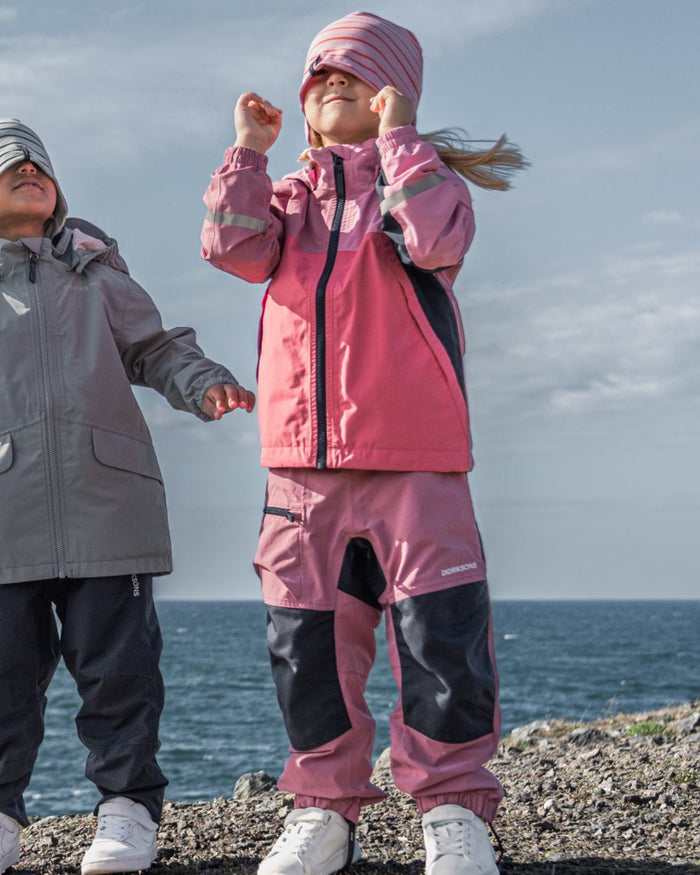 Heather Pink coloured Didriksons Childrens Dusk Pants on sea background #colour_heather-pink