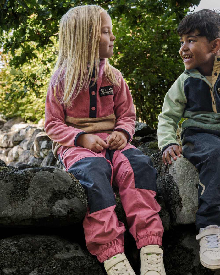 Heather Pink coloured Didriksons Childrens Dusk Pants on forest background #colour_heather-pink
