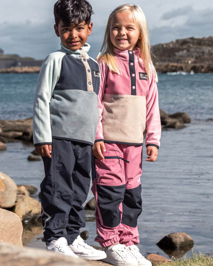 Heather Pink coloured Didriksons Childrens Monte Half Button Fleece 5 on sea background #colour_heather-pink