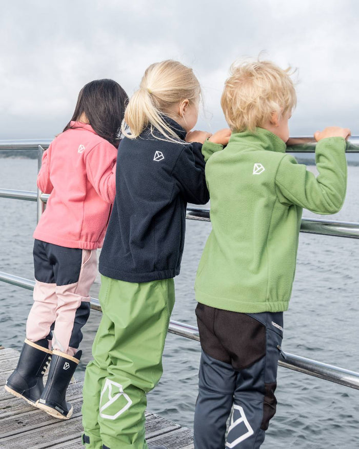 Algae Green coloured Didriksons Childrens Muskot Jacket on sea background #colour_algae-green