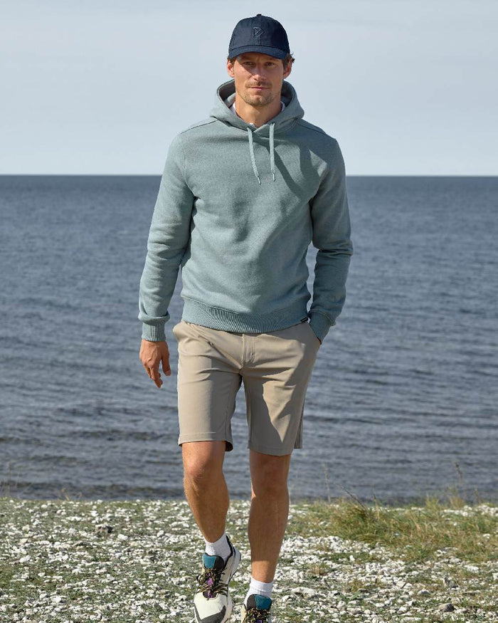 Dark Night Blue coloured Didriksons Derin Cap 2 on sea background #colour_dark-night-blue