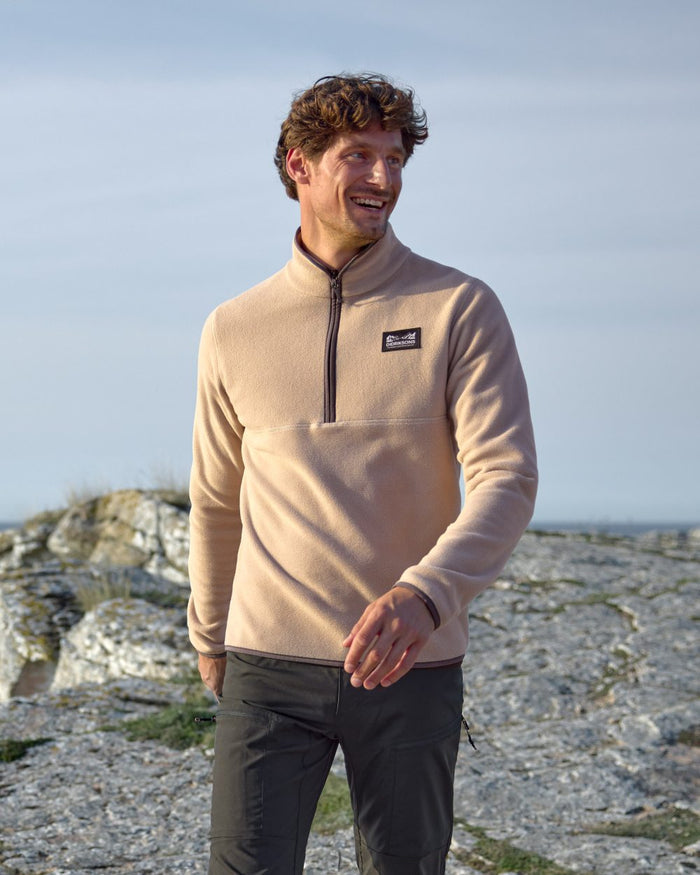 Beach Biege coloured Didriksons Mens Vito USX Half Zip Sweater on coastal background #colour_beach-beige