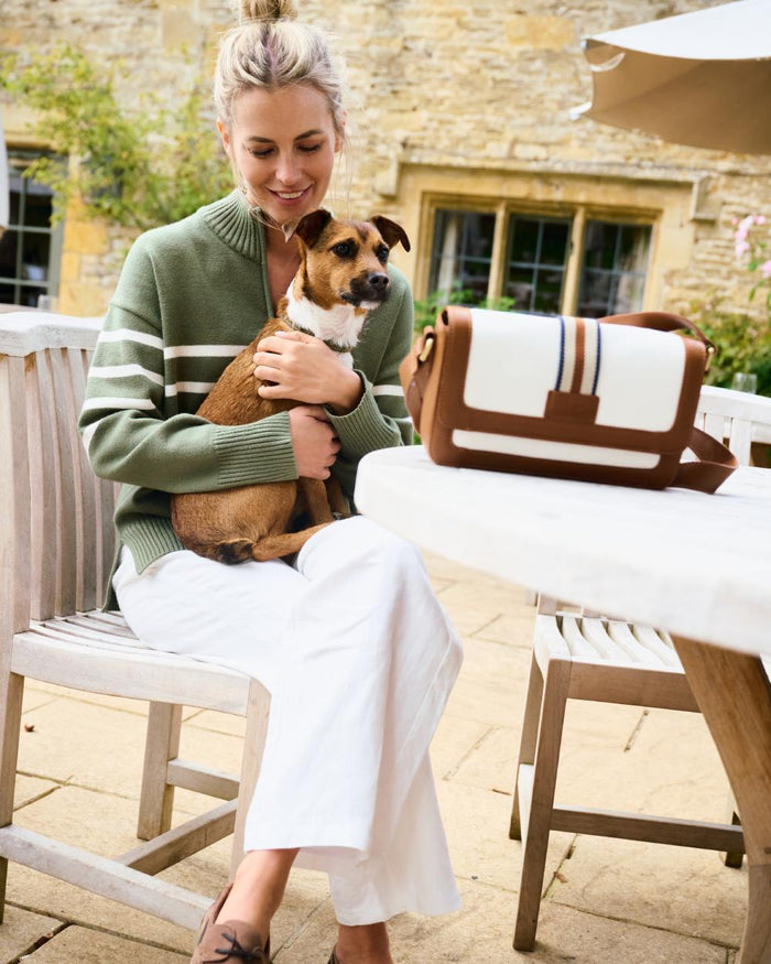 Caramel coloured Dubarry Hillsbrook Cross Body Bag on restaurant background #colour_caramel