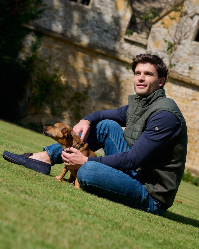 Olive coloured Dubarry Mens Solent Lightweight Hybrid Gilet on park background #colour_olive