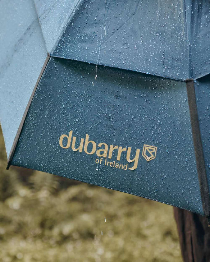 Navy coloured Dubarry Umbrella on blurry background #colour_navy