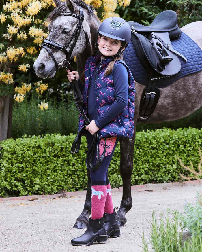 Navy Frolicking Horses coloured Dublin Childrens Patrice Everyday Puffer Vest on street background #colour_navy-frolicking-horses
