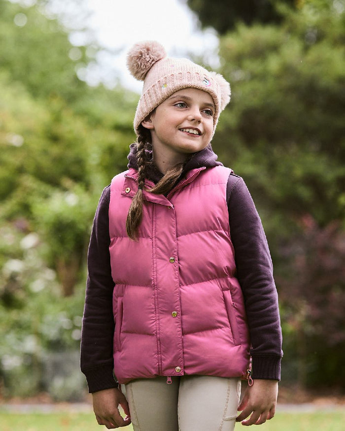 Red Violet coloured Dublin Childrens Patrice Everyday Puffer Vest on blurry background #colour_red-violet