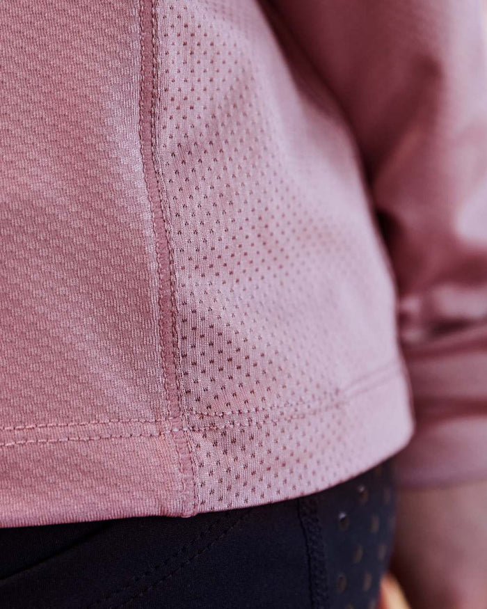 Dusty Rose coloured Dublin Kids Breathable Long Sleeve Riding Top on blurry background #colour_dusty-rose
