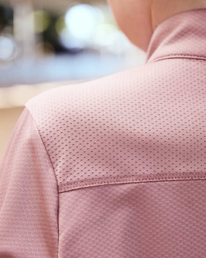 Dusty Rose coloured Dublin Kids Breathable Long Sleeve Riding Top on blurry background #colour_dusty-rose
