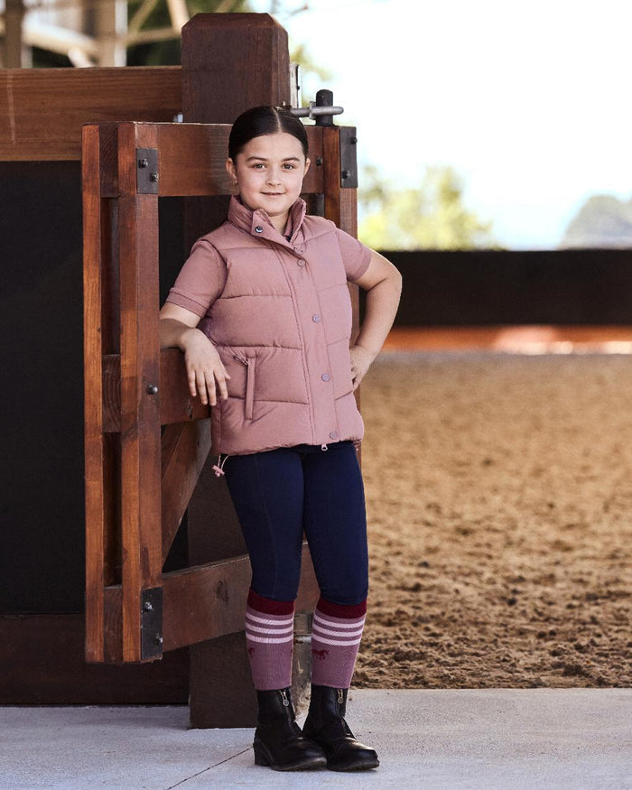 Dusty Rose coloured Dublin Kids Puffer Body Warmer on wood background #colour_dusty-rose