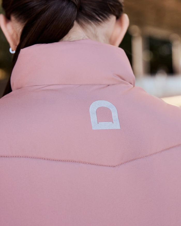 Dusty Rose coloured Dublin Kids Puffer Body Warmer on blurry background #colour_dusty-rose