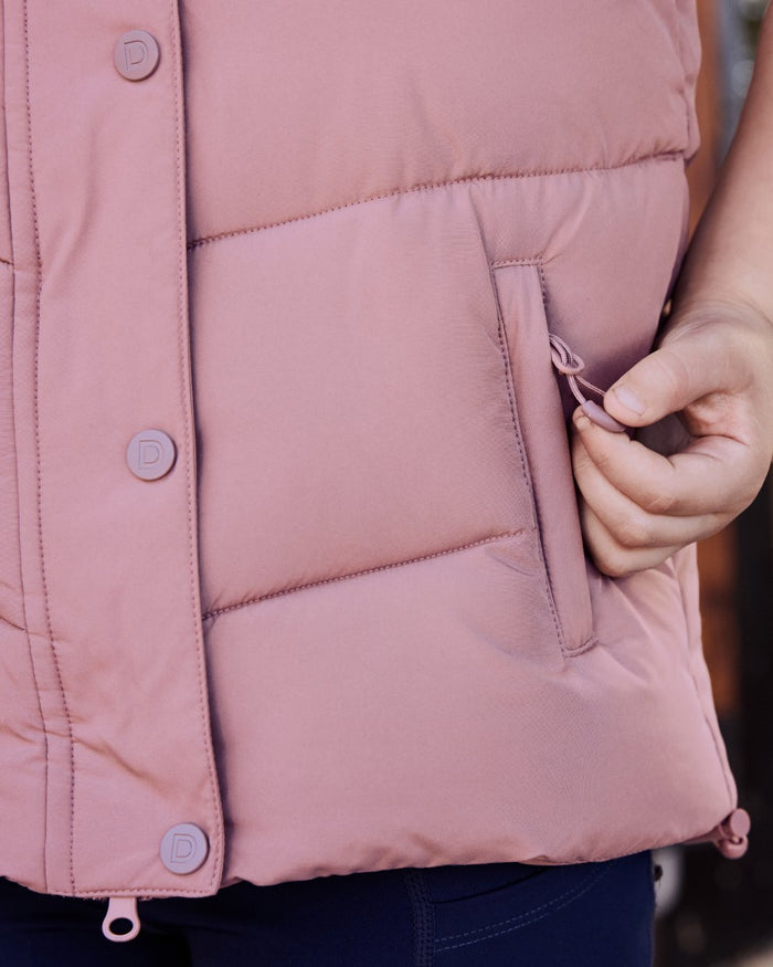 Dusty Rose coloured Dublin Kids Puffer Body Warmer on blurry background #colour_dusty-rose