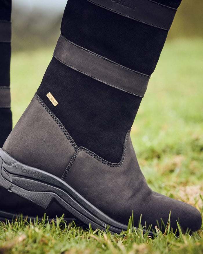 Black Coloured Dublin River Boots IV on grass background #colour_black
