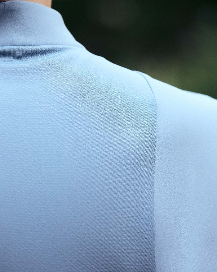 Blue Fog coloured Dublin Womens Brushed Long Sleeve Riding Top on  blurry background #colour_blue-fog