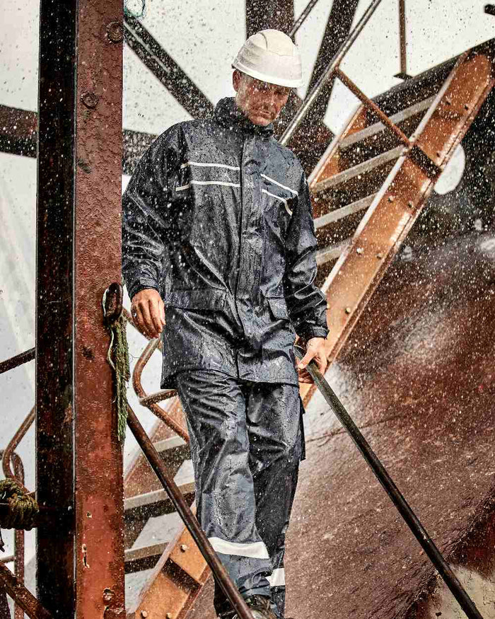 Navy Coloured Elka Mens Dry Zone D-Lux PU Long Rain Jacket on stairs background #colour_navy