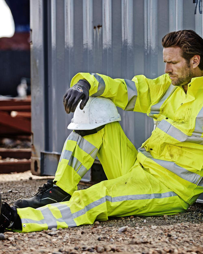 Fluorescent Yellow Coloured Elka Mens Dry Zone Visible Hi-Vis Rain Trousers With Vertical Reflective Stripes on construction background #colour_fluorescent-yellow