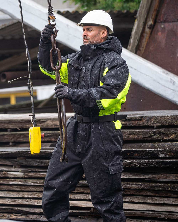 Black Fluorescent Yellow Coloured Elka Mens Working Xtreme Winter Thermal Coverall With Recycled Padding on construction background #colour_black-fluorescent-yellow