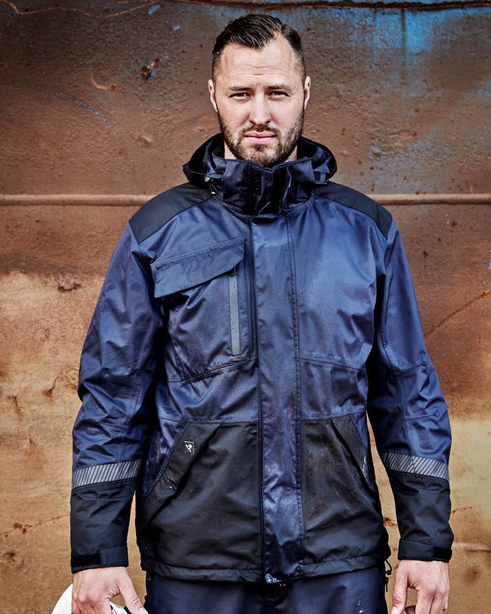 Navy Black Coloured Elka Mens Working Xtreme Stretch Jacket on construction background #colour_navy-black