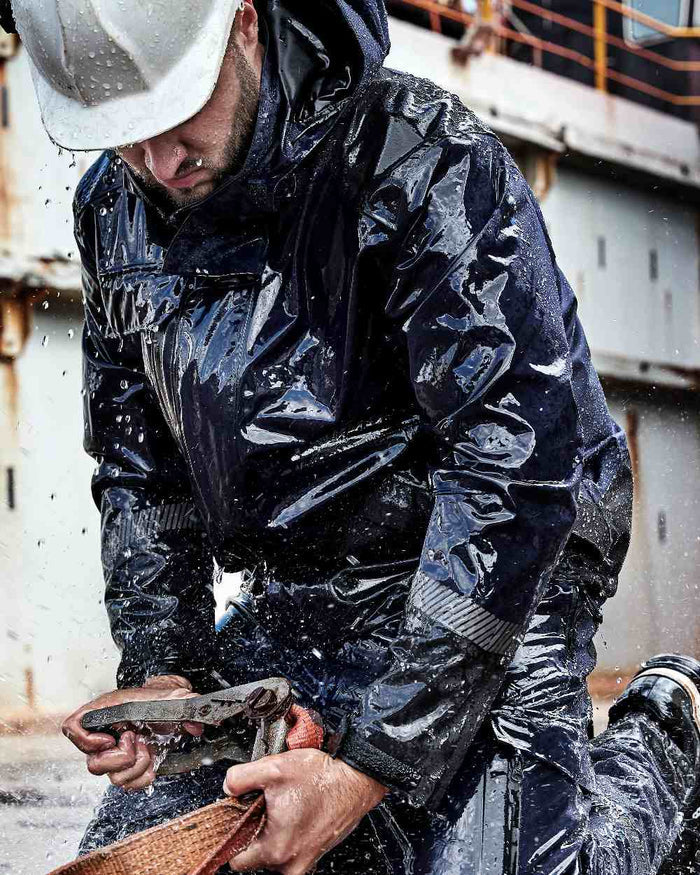 Navy Black Coloured Elka Mens Working Xtreme Stretch Jacket on construction background #colour_navy-black