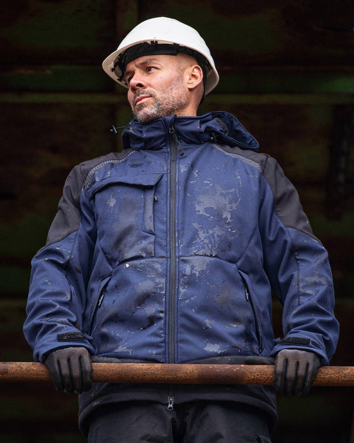 Navy Black Coloured Elka Mens Working Xtreme Winter Softshell Jacket on blurry background #colour_navy-black