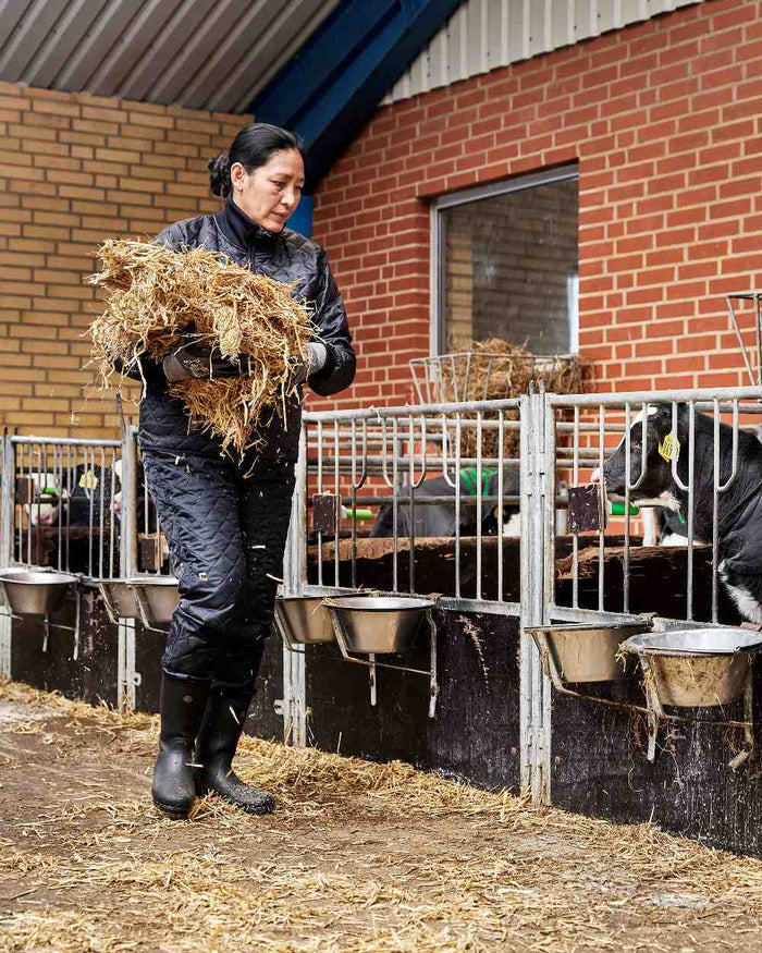 Black Coloured Elka Womens Thermal Jacket on barn background #colour_black