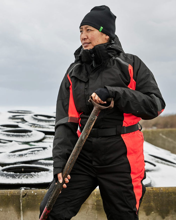 Black Red Coloured Elka Womens Working Xtreme Winter Thermal Coverall With Recycled Padding on snow background #colour_black-red
