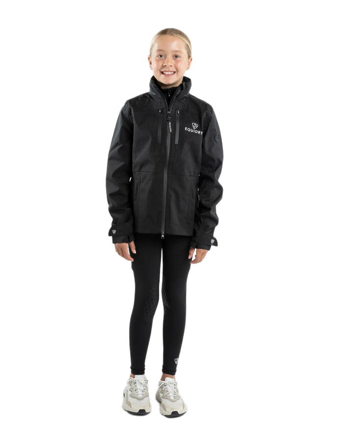 Black coloured Equidry Childrens Varsha Waterproof Jacket on white background #colour_black