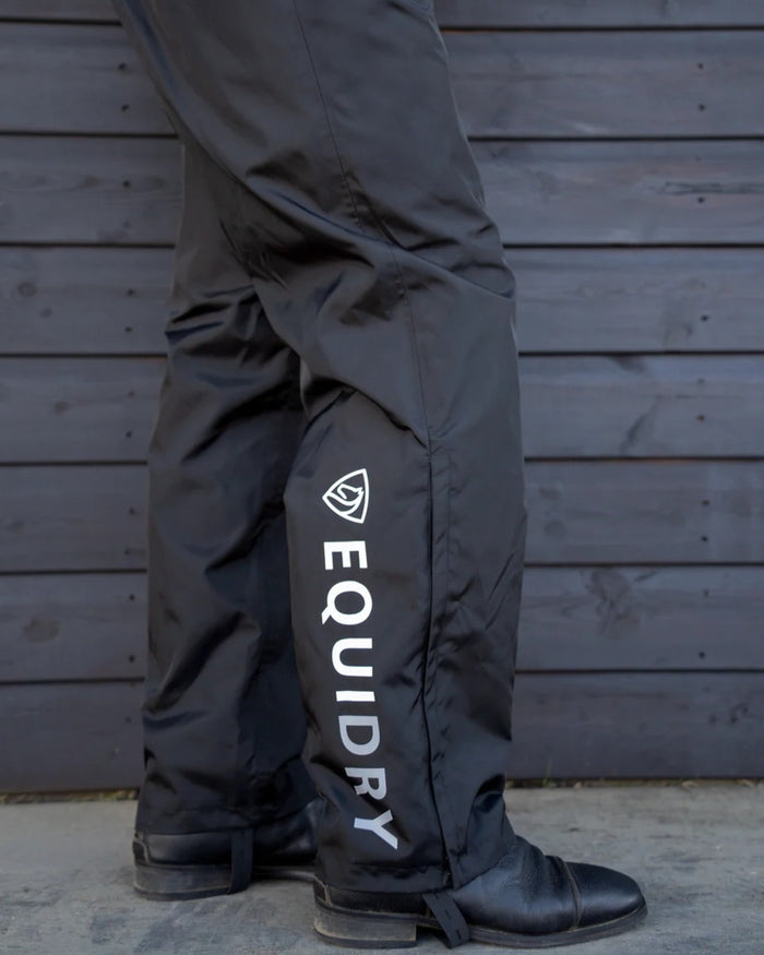 Black coloured Equidry Mens Fleece Lined Waterproof Trousers on outdoor background #colour_black