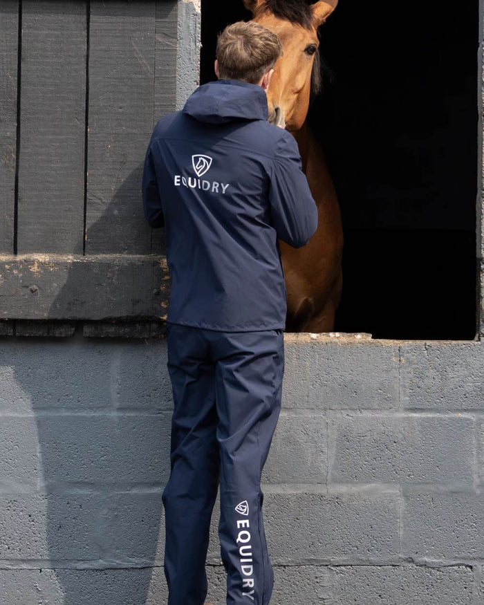 Navy coloured Equidry Mens Nimbus Pack Away Jacket With Stowaway Hood on outdoor background #colour_navy