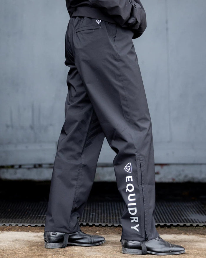 Black coloured Equidry Mens Unlined Waterproof Trousers on outdoor background #colour_black