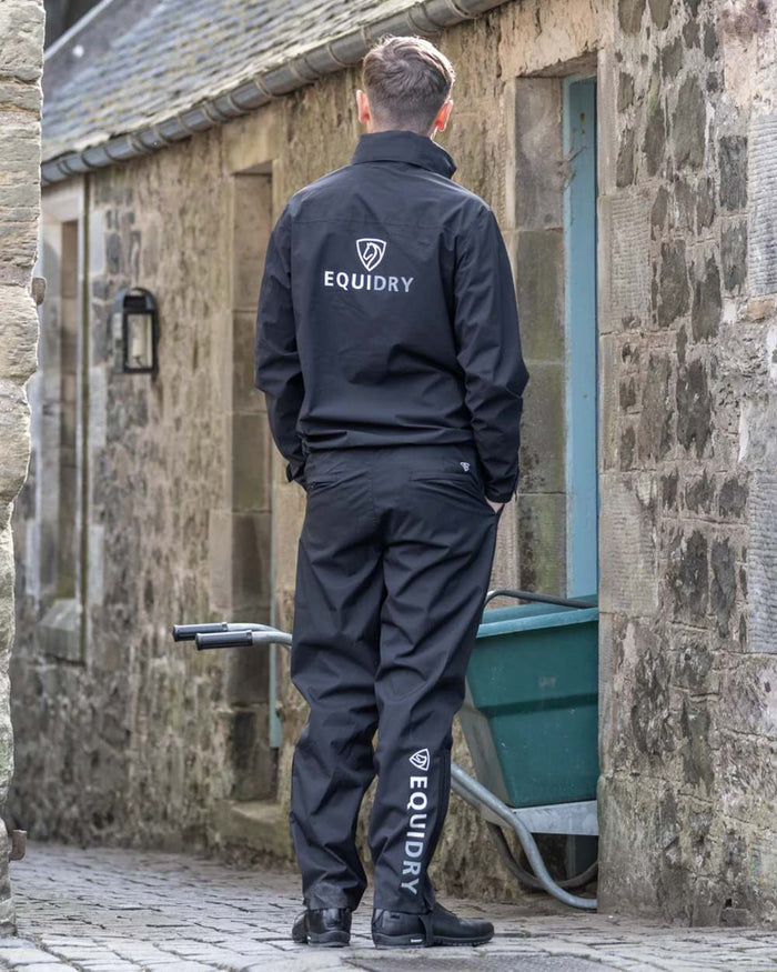 Black coloured Equidry Mens Unlined Waterproof Trousers on outdoor background #colour_black