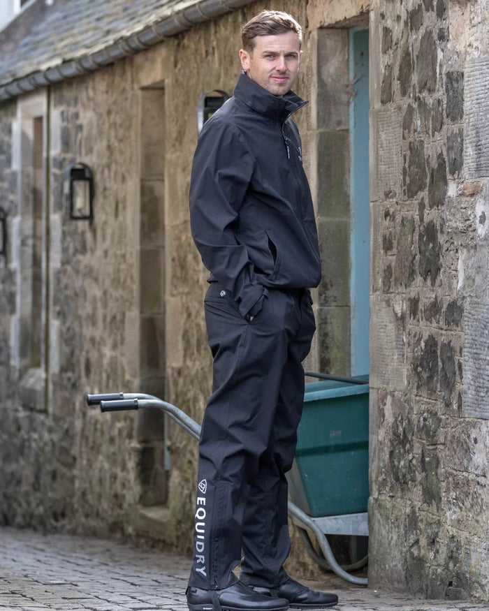 Black coloured Equidry Mens Unlined Waterproof Trousers on outdoor background #colour_black