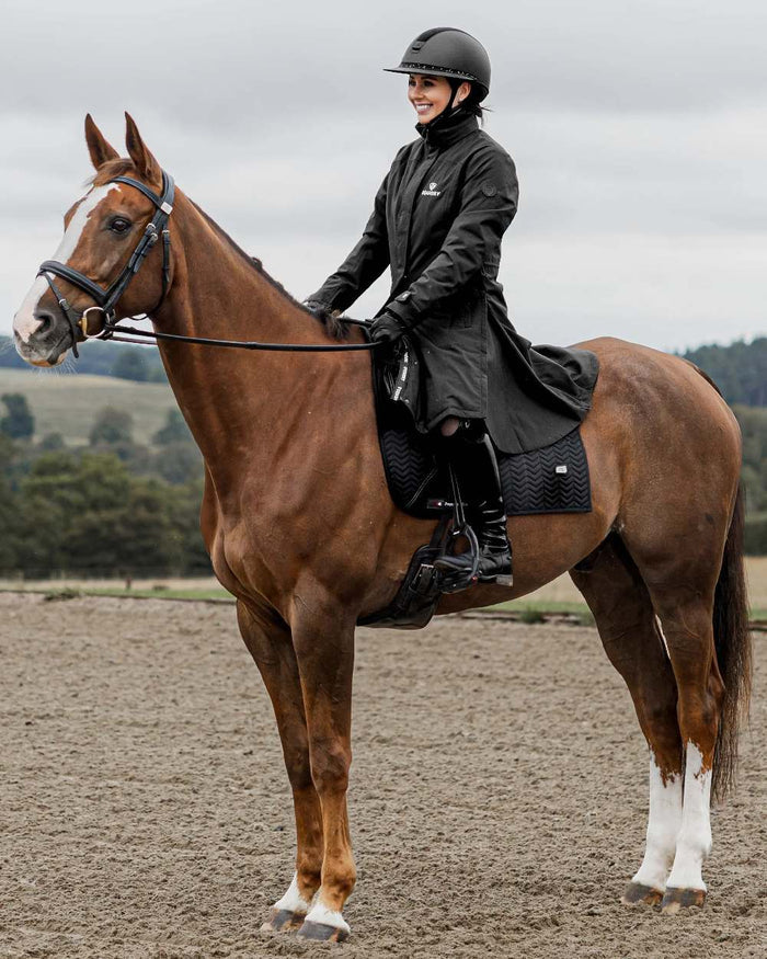 Black Coloured Equidry Womens Bronte Riding Coat With Removable Hood on outdoor background #hood_removable #colour_black