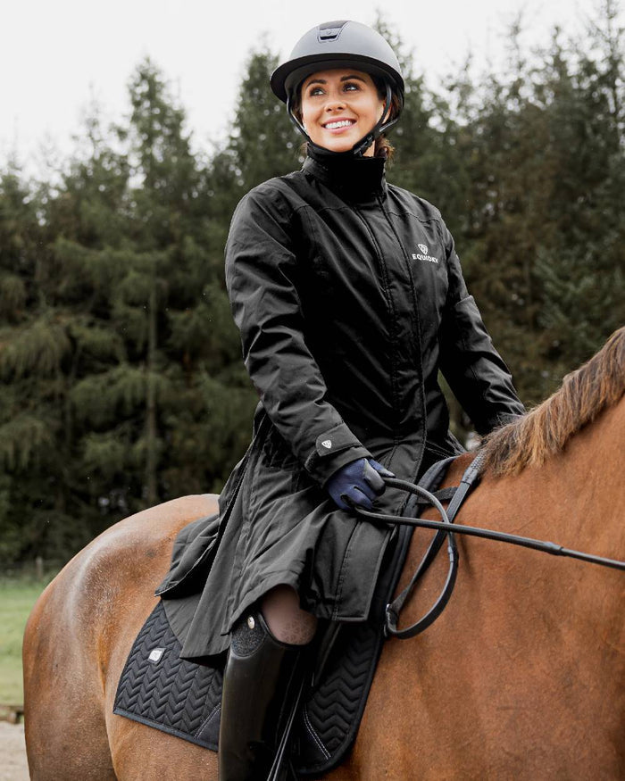 Black Coloured Equidry Womens Bronte Riding Coat With Removable Hood on outdoor background #hood_removable #colour_black