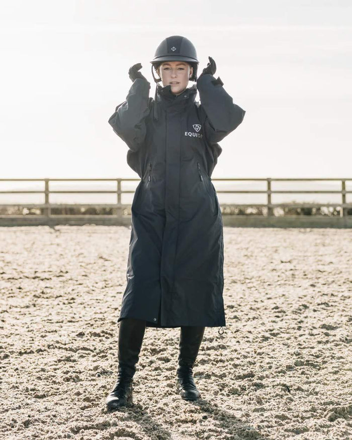 Black coloured Equidry Womens Equimac Evolution Jacket on farm background  #colour_black