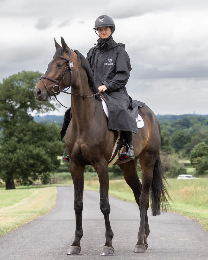Black coloured Equidry Womens Equimac Evolution Jacket on street background  #colour_black