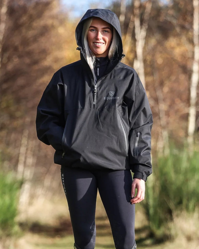 Black coloured Equidry Womens Storm Smock With Velour Lining on outdoor background #colour_black