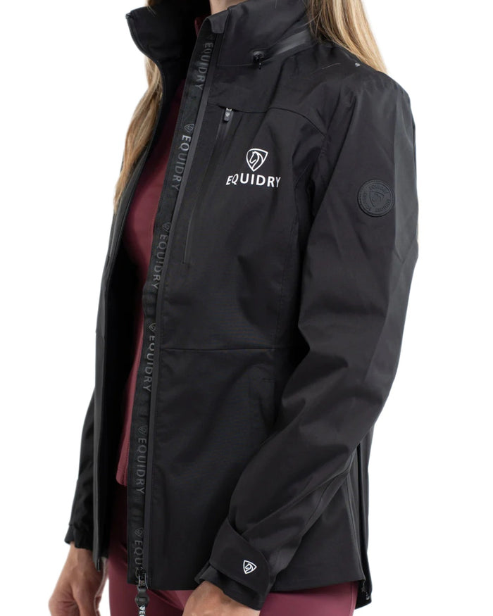 Black coloured Equidry Womens Varsha Jacket with Stowaway Hood on white background #colour_black