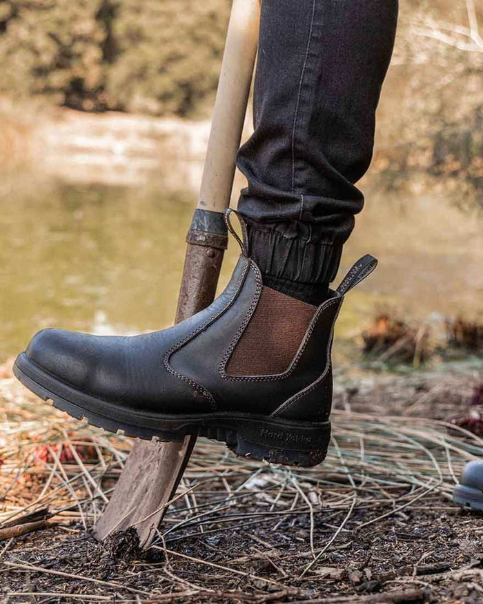 Brown Coloured Hard Yakka Outback Steel Toe Safety Dealer Boots on Outdoor Background
#colour_brown