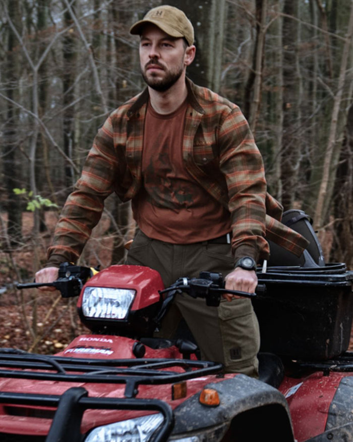 Autumn Orange Check coloured Harkila Aivak Long Sleeved Shirt on forest background #colour_autumn-orange-check