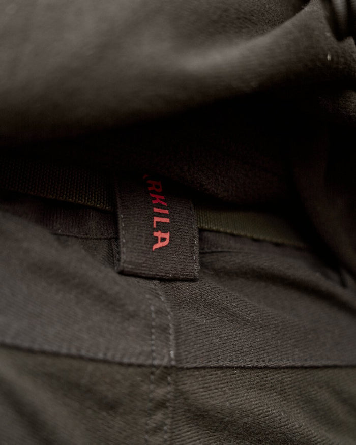 Hunting Green Shadow Brown Coloured Harkila Aspire HWS Trousers on forest background #colour_hunting-green-shadow-brown