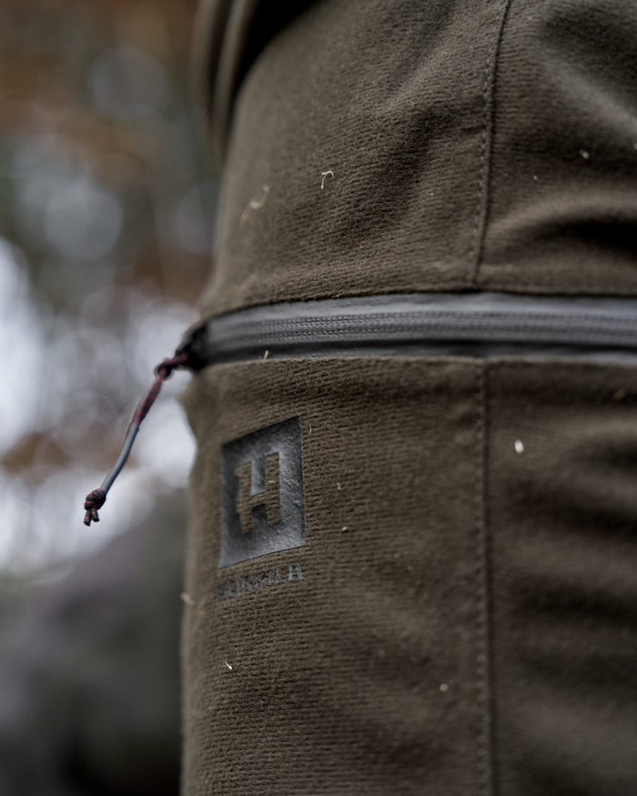 Hunting Green Shadow Brown Coloured Harkila Aspire HWS Trousers on forest background #colour_hunting-green-shadow-brown