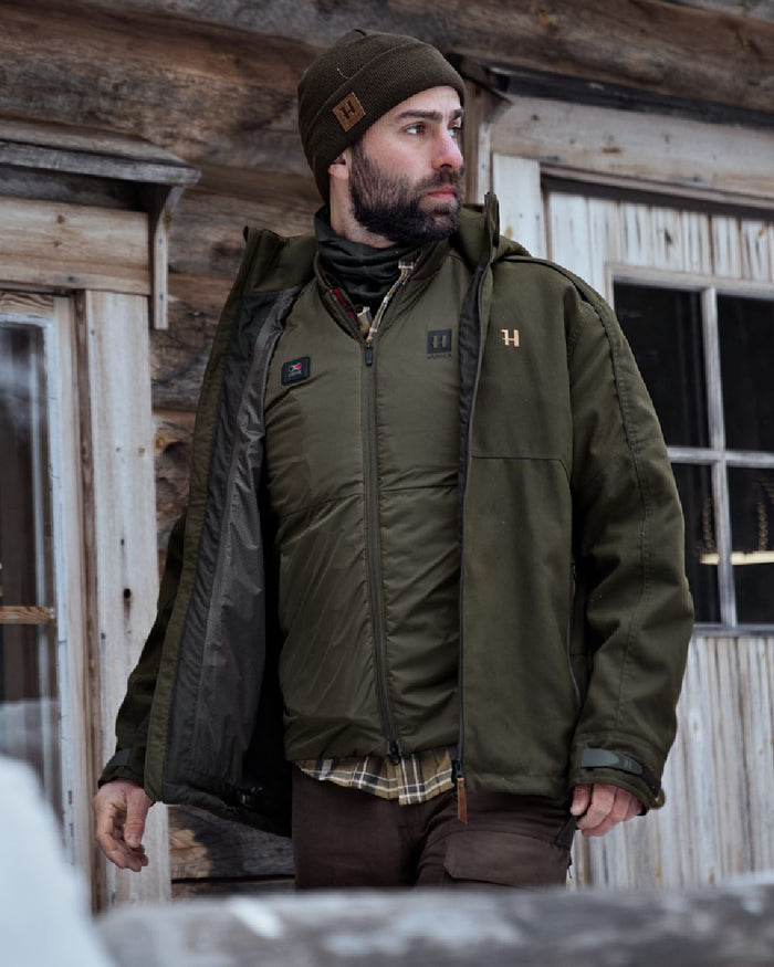 Willow Green Coloured Harkila Clim8 Base Waistcoat on house background #colour_willow-green