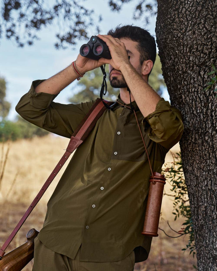 Dark Olive Willow Green Coloured Harkila Kenmore Cl. Flat Cap on forest background #colour_dark-olive-willow-green