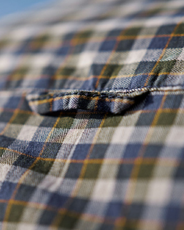 Naval Blue Check Coloured Harkila Mens Fjell Short Sleeve Shirt on blurry background #colour_naval-blue-check